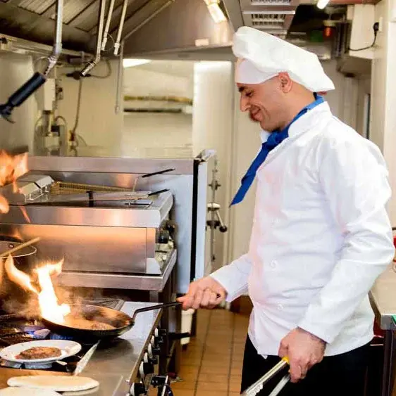Cypress Springs Chef Created Meals, chef frying a dish.