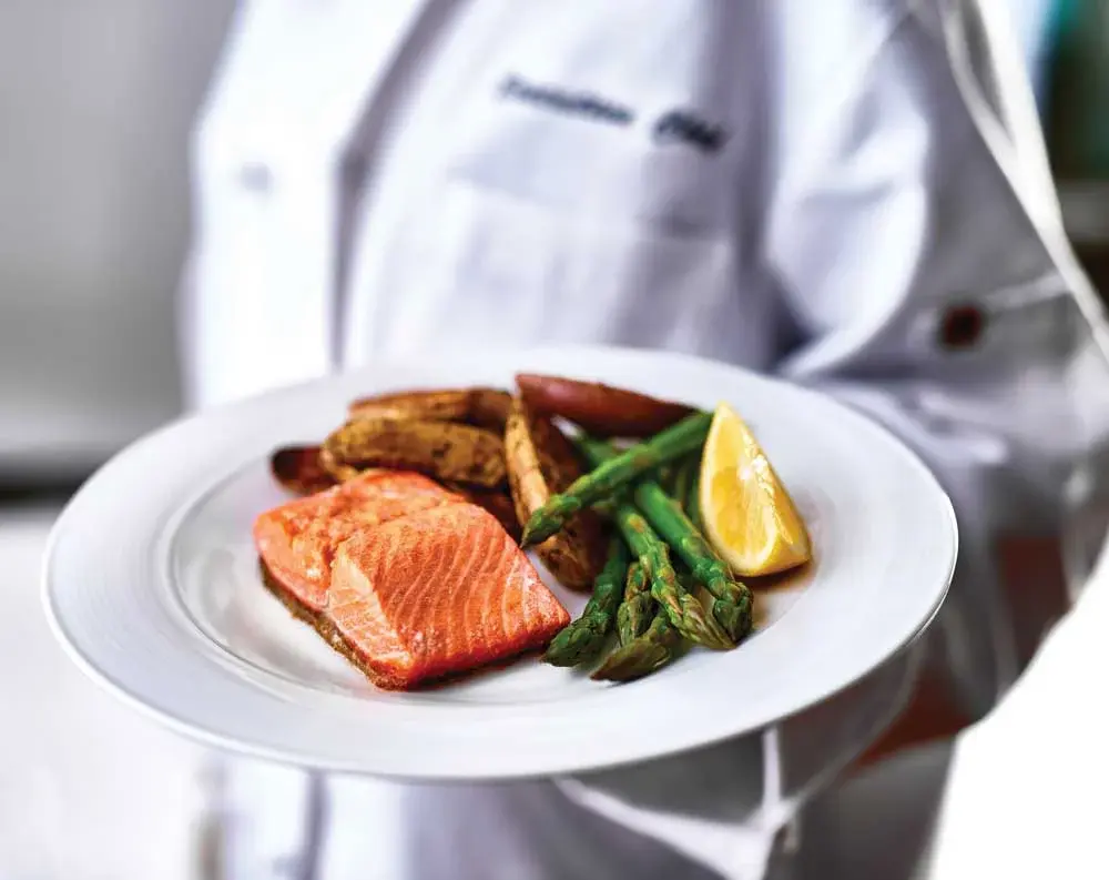 Cypress Springs Chef Created Meals, chef delivering a finished dish.